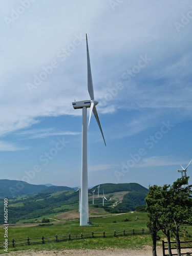 
This is a hillside landscape with a wind turbine.