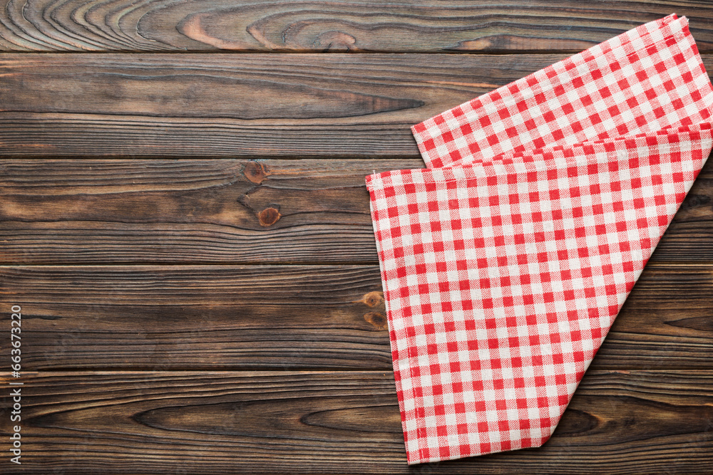 Obraz premium top view with red empty kitchen napkin isolated on table background. Folded cloth for mockup with copy space, Flat lay. Minimal style