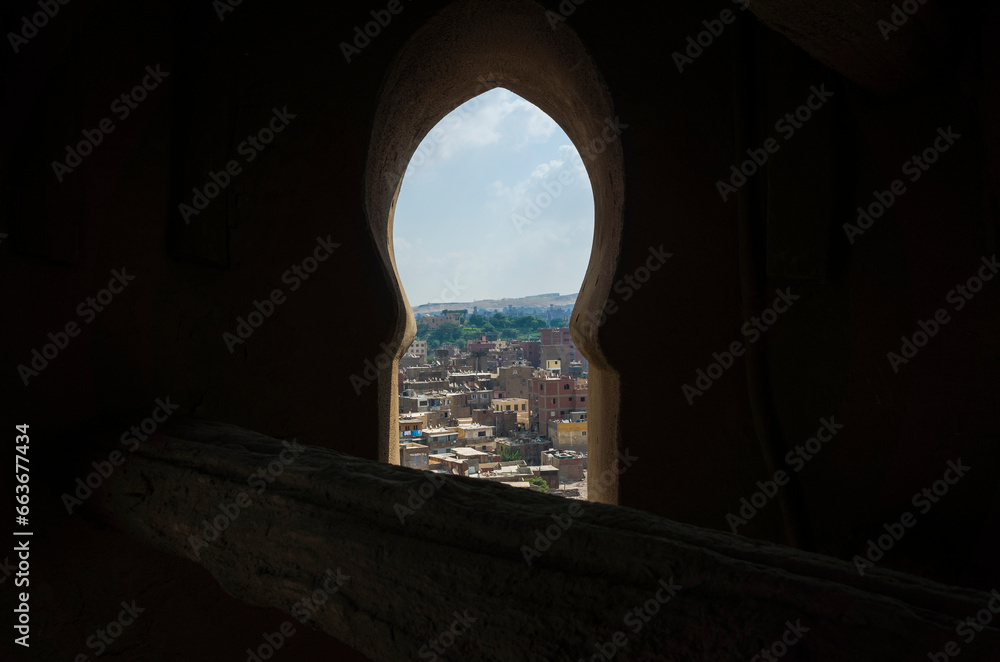 Cairo city view framed with the window of the minaret tower of Sultan Qansuh Al-Ghuri Complex, Dense buildings Egypt