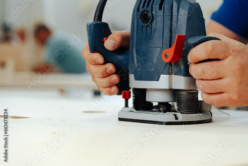 Wallpaper Mural Close up of male carpenter working with piece of wood in a workshop Torontodigital.ca
