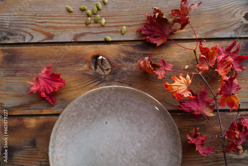 Round dish on a wooden background with leaves. Autumn atmosphere.