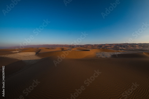 Beautiful golden desert dunes of Liwa in Abu Dhabi UAE during sunset time