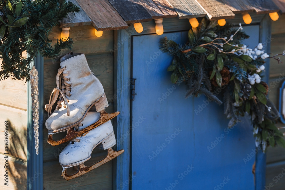 Obraz premium Beautiful holiday decorations. Rusty figure skating skates. Beautiful Christmas background. The concept of decorations and decor for the new year. New Year's card 2024.
