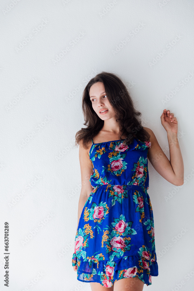 Brunette posing on white background in bright room Brunette posing on white background in bright room