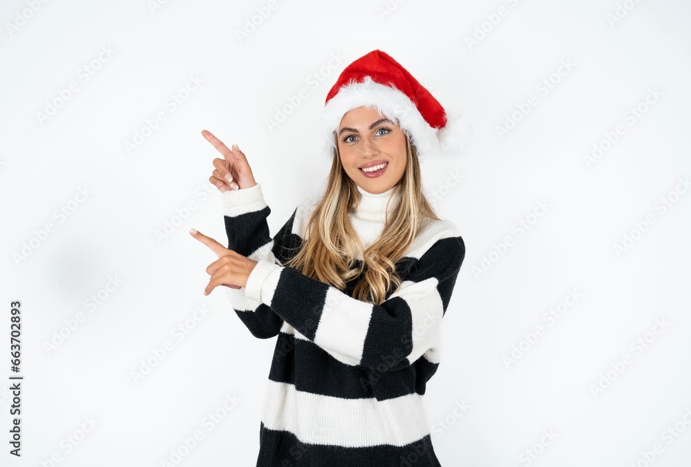 Young beautiful woman indicating finger empty space showing best low prices, looking at the camera Young beautiful woman indicating finger empty space showing best low prices, looking at the camera