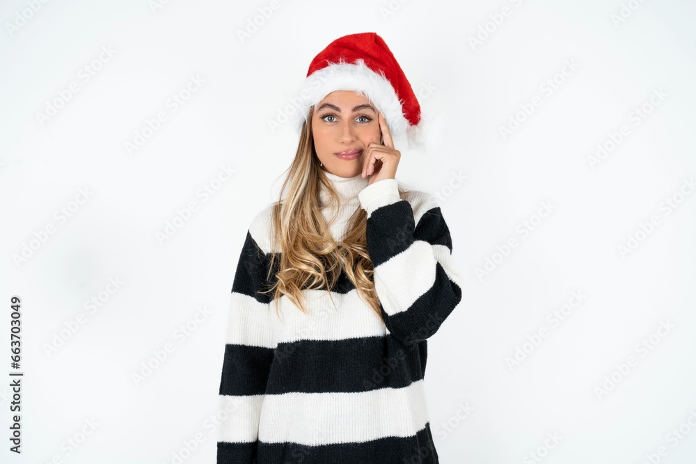 Young beautiful woman tries to memorize something, keeps fore finger on temple, reminds information for exam, Young beautiful woman tries to memorize something, keeps fore finger on temple, reminds information for exam,