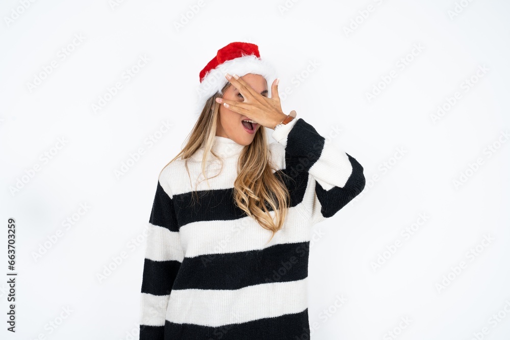 Young beautiful woman peeking in shock covering face and eyes with hand, looking through fingers with embarrassed expression. Young beautiful woman peeking in shock covering face and eyes with hand, looking through fingers with embarrassed expression.