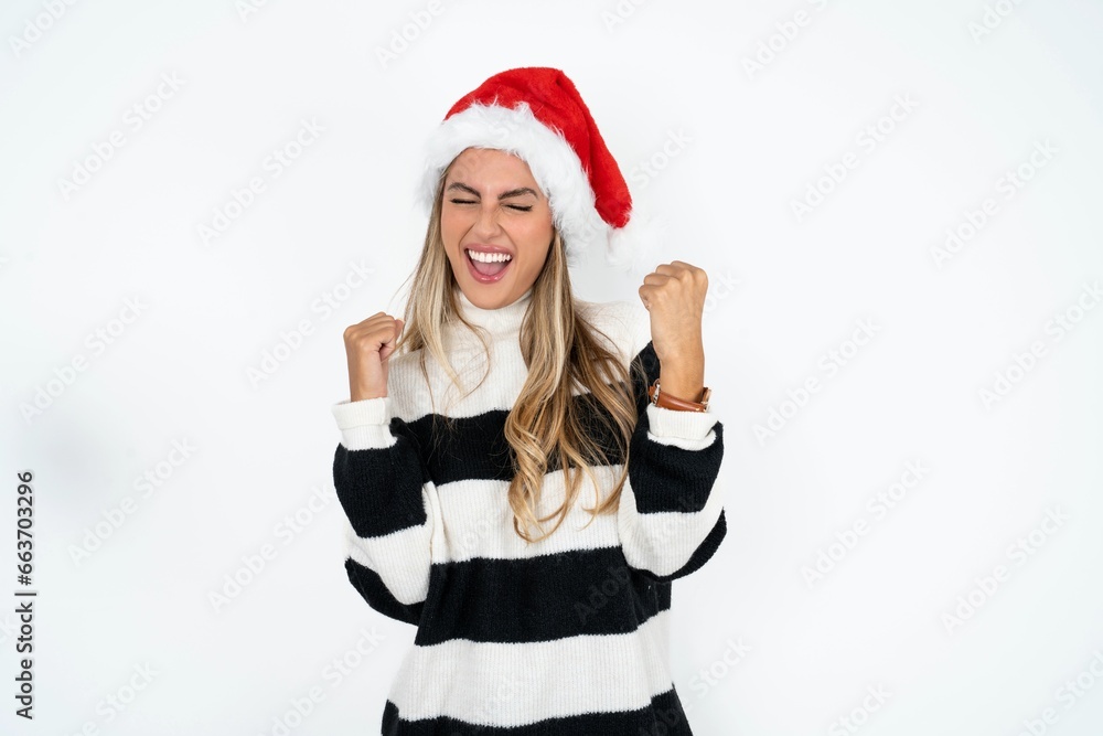 Young beautiful woman very happy and excited doing winner gesture with arms raised, smiling and screaming for success. Celebration concept. Young beautiful woman very happy and excited doing winner gesture with arms raised, smiling and screaming for success. Celebration concept.