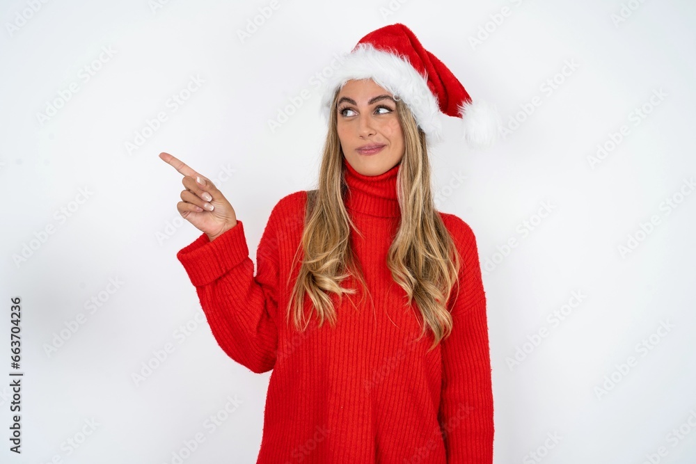 Young beautiful woman points at copy space and advertises something, advices best price. Young beautiful woman points at copy space and advertises something, advices best price.