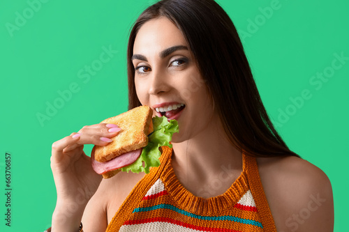 Young woman eating tasty sa...