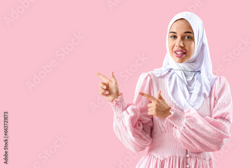 Stylish Muslim woman pointi...