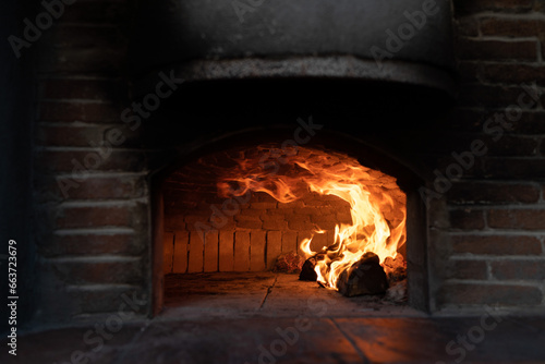 Red brick oven with wood fire.