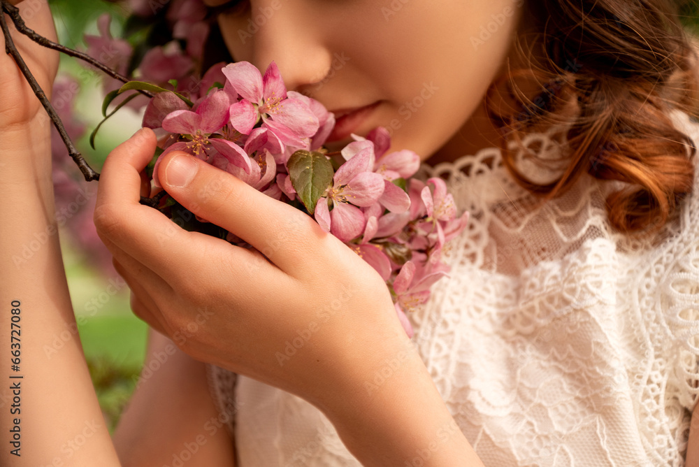 young woman smell pink flowers of  blooming apple tree on branch in spring - obrazy, fototapety, plakaty 