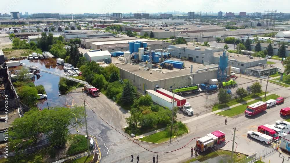 Fire Trucks In The Street Near The Industrial Burned Down In Toronto, Canada. - aerial Fire Trucks In The Street Near The Industrial Burned Down In Toronto, Canada. - aerial