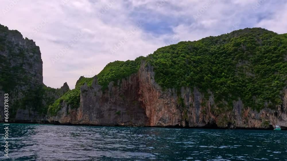 Phi Phi island off the coast of phuket thailand. Phi phi island is famous for turquoise clear blue waters teaming with Corel reef fish white soft sand and lush green trees. Phi Phi island off the coast of phuket thailand. Phi phi island is famous for turquoise clear blue waters teaming with Corel reef fish white soft sand and lush green trees.