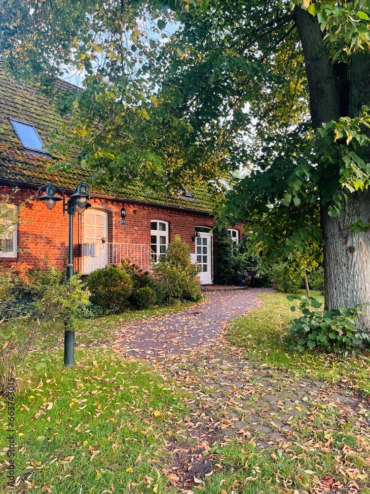 Countryside house outside, autumn time, falling leaves Countryside house outside, autumn time, falling leaves