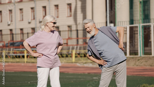 Old grandparents enjoy morning warmup together. Two cute love couple sport practicing. Elder nice pensioners fun smile. Fit stretching sportswear. Senior people workout exercise. Aged pair training.