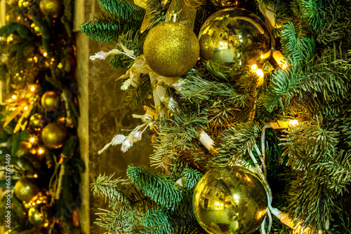 holiday decorations foe christmas and new year with shibibg girland , green fir and pine tree branches and christmas balls photo