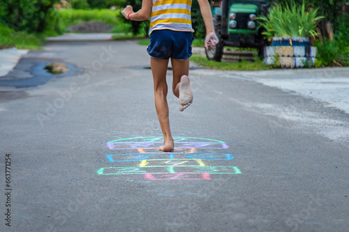 Children play hopscotch on the street. Selective focus.