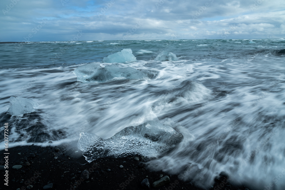Broken ice on black beach in sea water in Iceland Broken ice on black beach in sea water in Iceland
