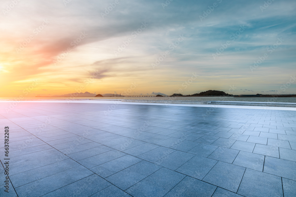 Empty square floor and coastline with sky clouds at sunset