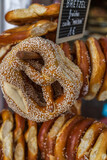 Freshly baked, sesame pretzels, hanging on a tree stand, for sale at a market in Strasbourg, France on the German border. Traditional snack for beer and Oktoberfest.