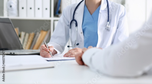 Stethoscope head lying on medical forms closeup while medicine doctor working in background. Patient history list visit check 911 medical calculation and statistics healthy lifestyle concept