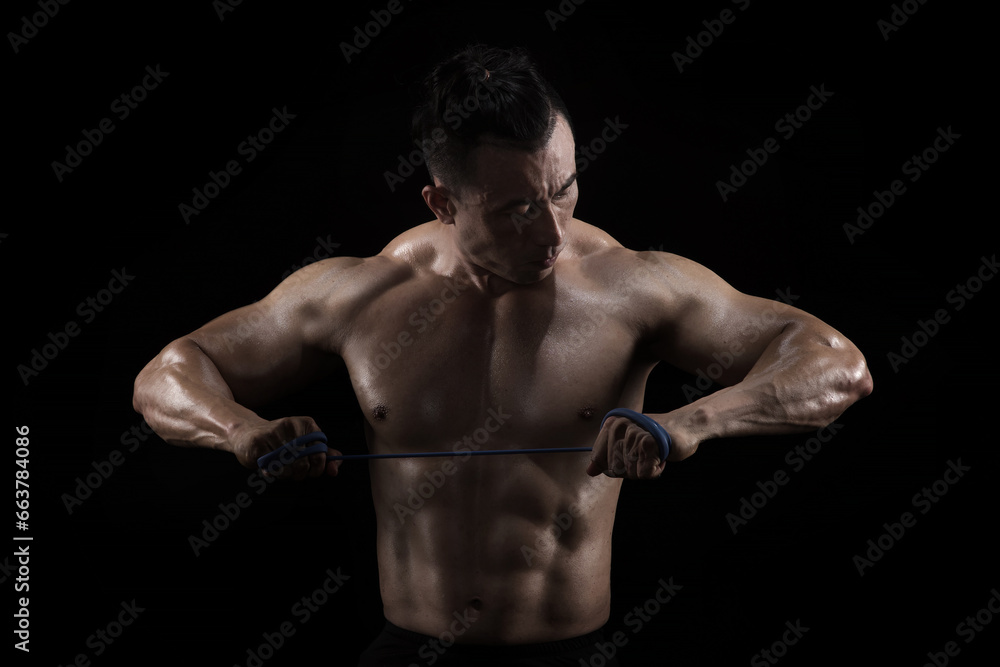 Strong, fit and sporty bodybuilder man over black background