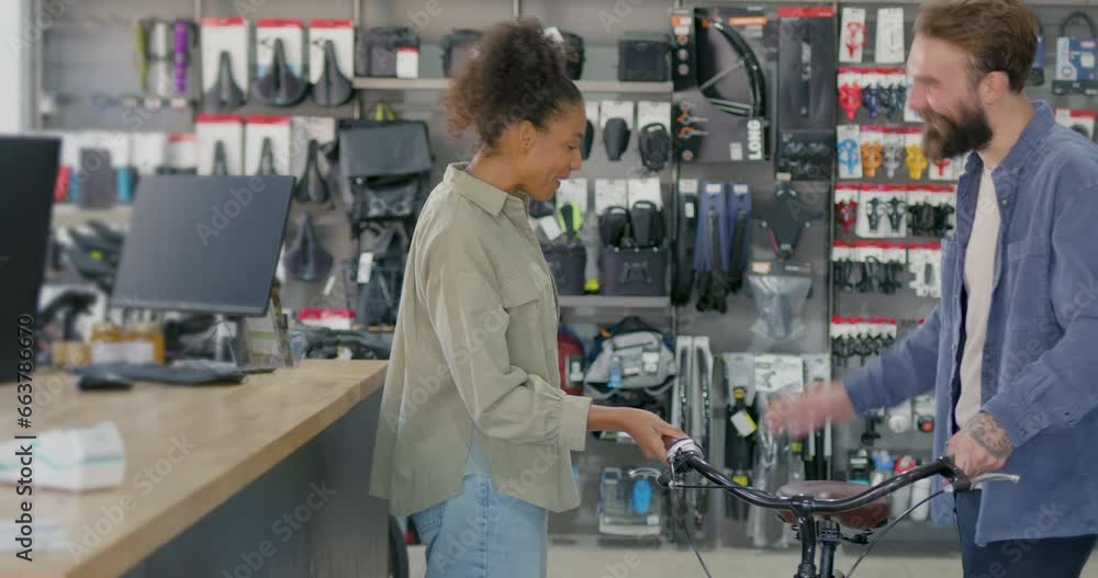 Female Customer Purchasing Bicycle in Store with Small Business Owner Female Customer Purchasing Bicycle in Store with Small Business Owner