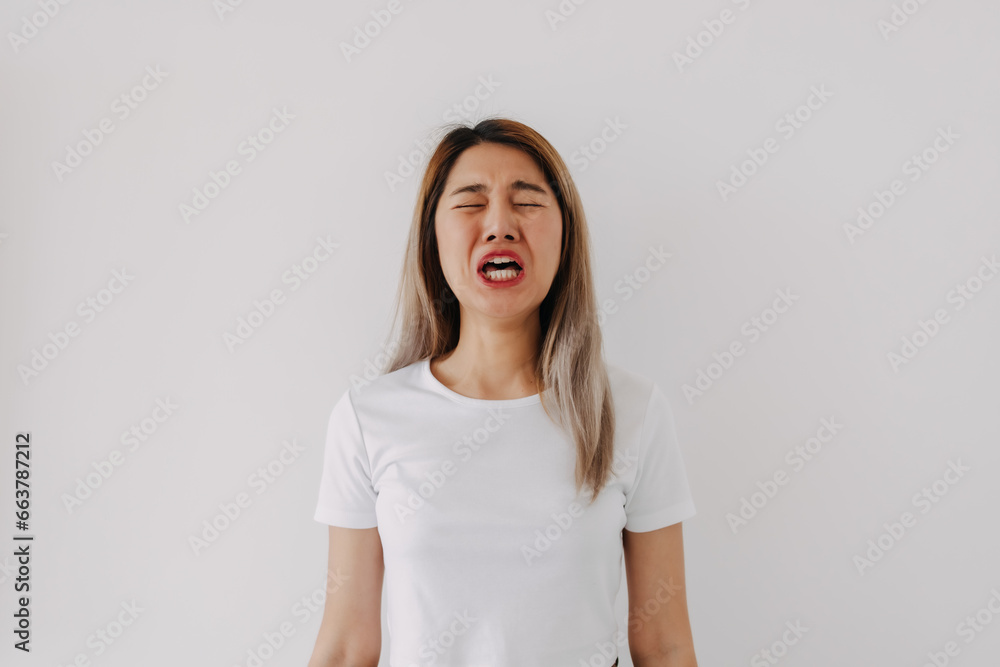 Asian Thai woman standing isolated over white background, funny ugly face sad crying, feeling very upset and unhappy. Asian Thai woman standing isolated over white background, funny ugly face sad crying, feeling very upset and unhappy.