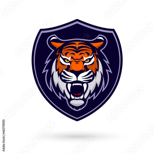 Fototapeta Naklejka Na Ścianę i Meble -  This fierce and powerful tiger mascot head logo, set within a shield, represents strength and competitiveness. Perfect for esport and gaming teams, it features a white background for versatility