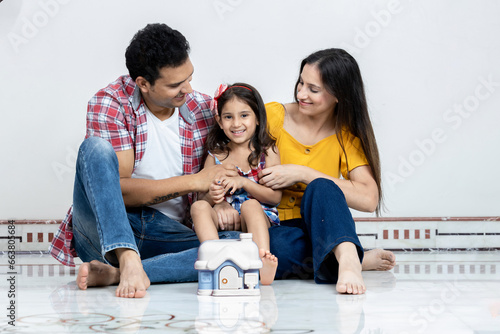 Parents Having Fun With Their Little Daughter At Home parents relaxing together with mortgage or house insurance