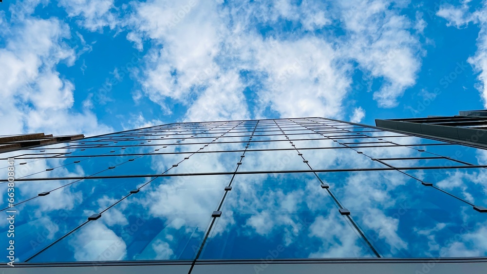 building Looking up tall glass and steel high rise. Cloudy sky building Looking up tall glass and steel high rise. Cloudy sky