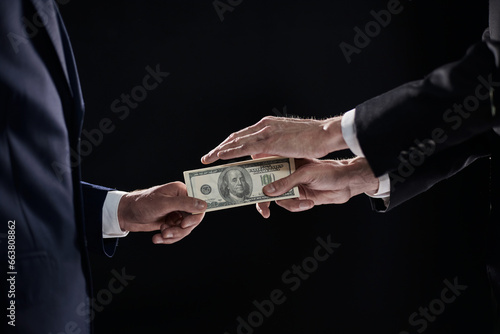 transferring money from hand to hand on a black background