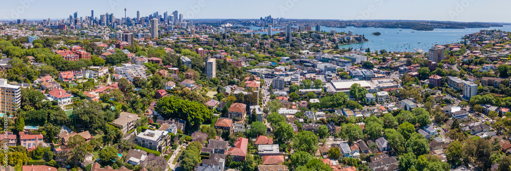 Fototapeta premium Panoramic aerial drone view above the harbourside suburb of Double Bay in east Sydney, NSW Australia looking toward Darling Point, Sydney Harbour and Sydney City on a sunny day