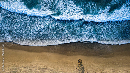 Beach from above with beautiful waves and spray