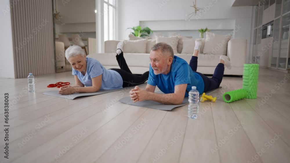 Senior couple man woman resting lying on mats after yoga practice at home. Family positive happy wife husband talking discussing training. Sport, active healthy lifestyle, fitness workout concept. Senior couple man woman resting lying on mats after yoga practice at home. Family positive happy wife husband talking discussing training. Sport, active healthy lifestyle, fitness workout concept.
