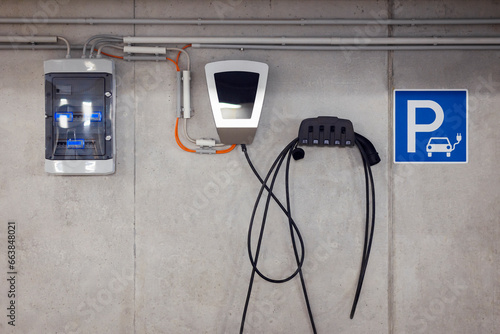 Charging Station Equipment for Electric Car in Underground Car Parking Garage with ev Charger Battery, Swichboard or Control Power Panel. photo