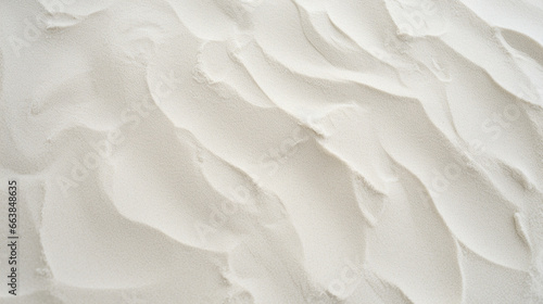 Top view of white sand, captured in close-up detail, displaying textured grains. photo