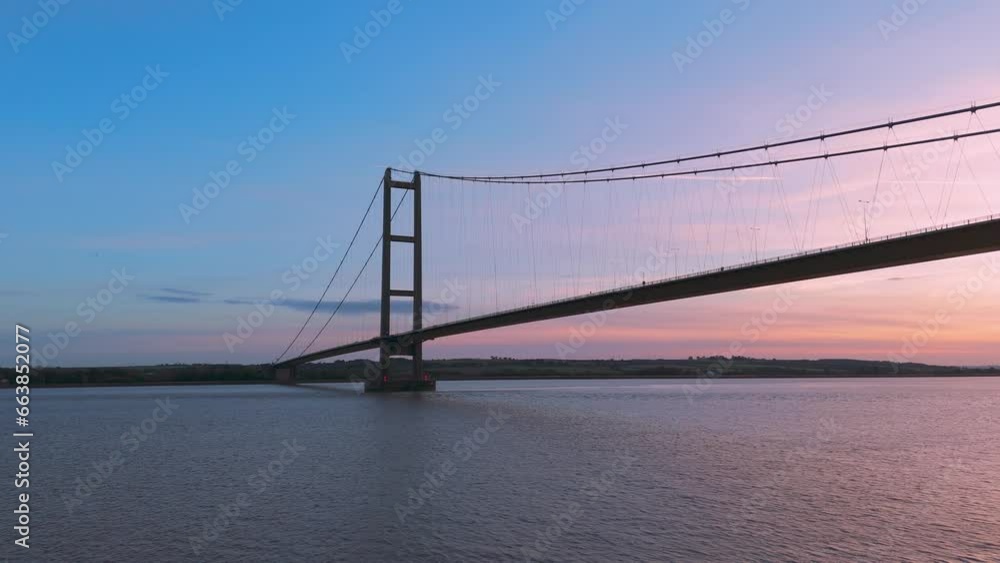 A drone's eye view: Humber Bridge, sunset, and cars painting a vibrant canvas of motion A drone's eye view: Humber Bridge, sunset, and cars painting a vibrant canvas of motion