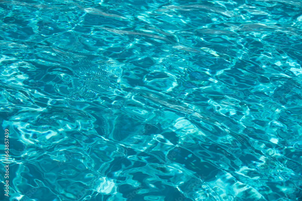 Water background, ripple waves. Blue swiming pool pattern. Sea surface. Water in swimming pool with sun reflection. Banner with copy space. Water background, ripple waves. Blue swiming pool pattern. Sea surface. Water in swimming pool with sun reflection. Banner with copy space.