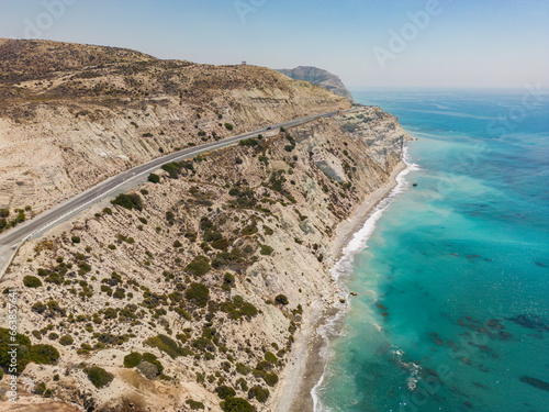 Panoramic view of rocky coast with turquoise water and clear blue sky in Paphos, Cyprus.