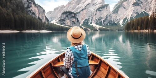 a woman riding a boat in front with a cap, looking at the mountain view, generative ai.