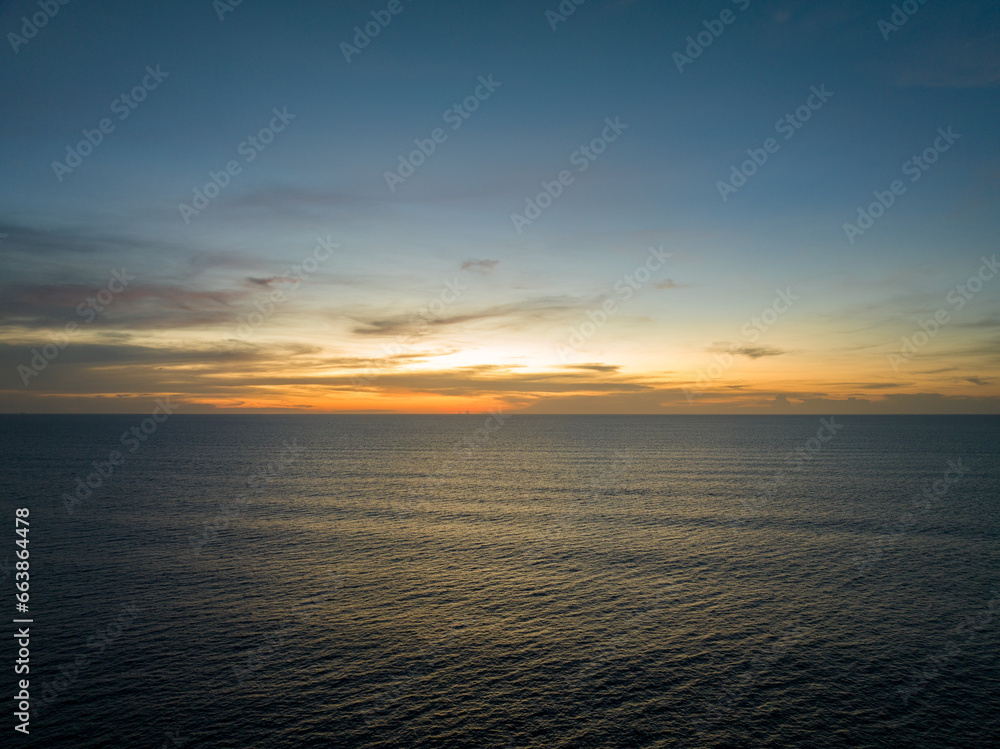 Naklejka premium Aerial view sunset sky over sea,Nature Light Sunset or sunrise over ocean,Colorful dramatic scenery sky, Amazing clouds and waves in evening sky, Beautiful light nature background