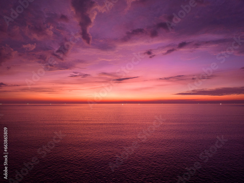 Aerial view sunset sky over sea,Nature Light Sunset or sunrise over ocean,Colorful dramatic scenery sky, Amazing clouds and waves in evening sky, Beautiful light nature background © panya99