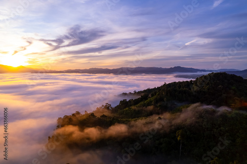 Amazing Sunrise or sunset over mountains hills covered with mist, Aerial view landscape drone shot beautiful colorful nature background