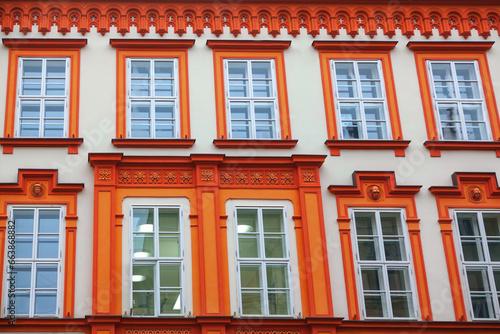 Colorful windows with stucco on the facade of an old house