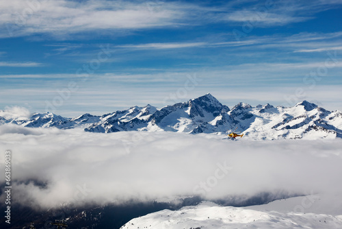 Aerial view of the Italian Alps in winter with snow and clouds. © Андрей Иванов