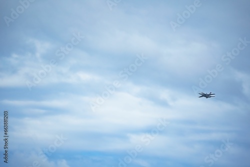 Commercial airliner flying in a bright blue sky during the day