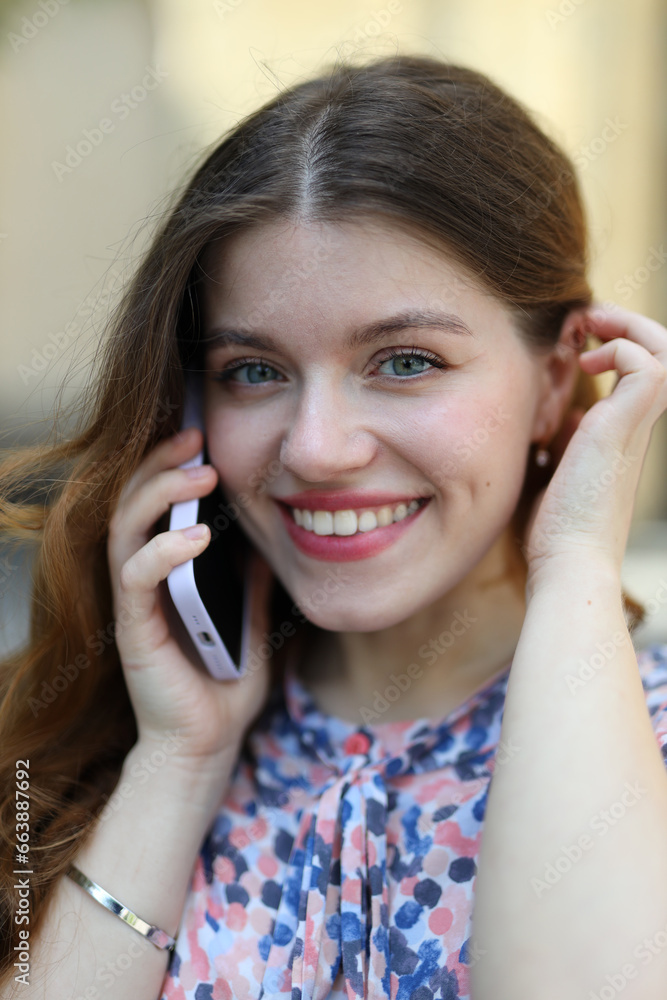 A happy young woman using her smartphone, enjoying a cheerful conversation in a city, radiating modern technology and outdoor leisure. A happy young woman using her smartphone, enjoying a cheerful conversation in a city, radiating modern technology and outdoor leisure.